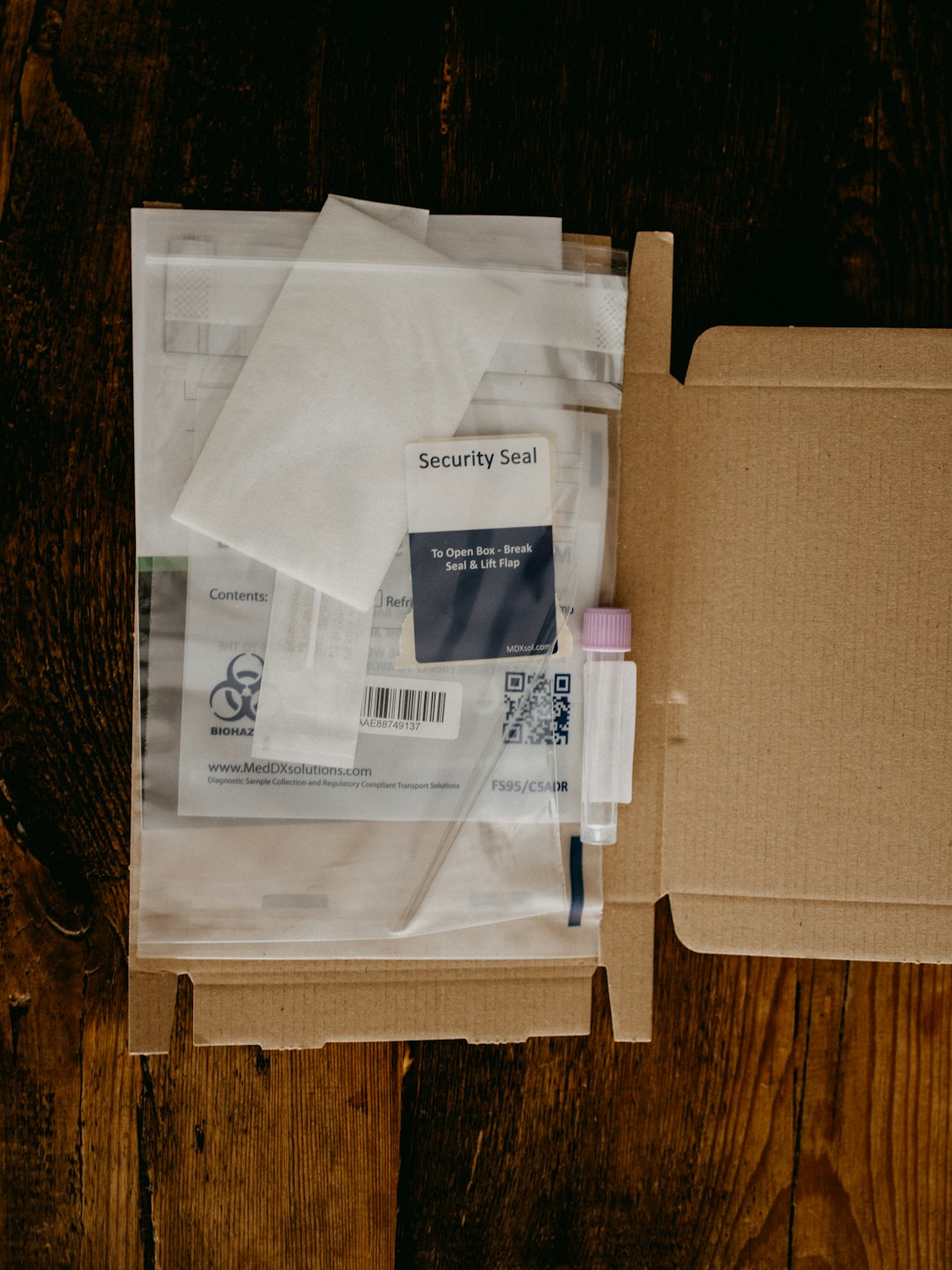 Medical sample kit in an open cardboard box.